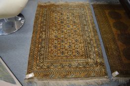 A gold ground Afghan style rug.