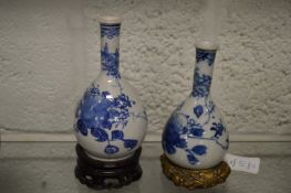 Two small Chinese blue and white bottle vases on stands.
