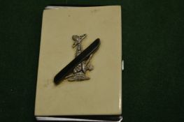 A stylish ladies' compact decorated with an aeroplane.