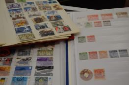 Three stamp albums and contents.