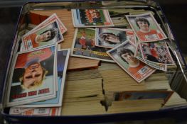 A large collection of football cards and similar items.