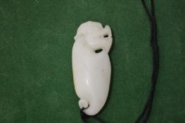 A Chinese carved white jade pendant.