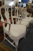 A set of four continental distress painted dining chairs, two with arms.
