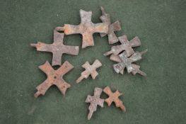 Ten small bronze Roman crosses.