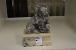 A Chinese soapstone figure of a lion dog.