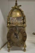 A small brass lantern clock.