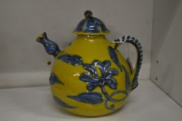 A Chinese yellow ground pottery teapot and cover.