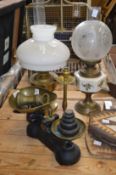Kitchen scales and weights, a brass candlestick and two oil lamps.