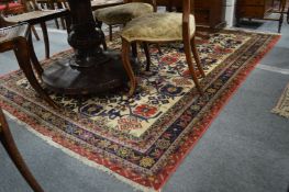 A Persian design carpet, beige ground with stylized decoration.