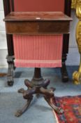 A 19th century mahogany work table with unusual carved base.