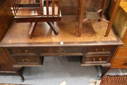 An Edwardian mahogany desk on cabriole legs.