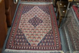 A Kilim style rug, cream ground with allover stylized decoration.
