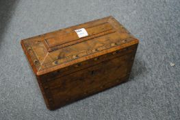 A Victorian figured walnut sarcophagus shaped tea caddy.