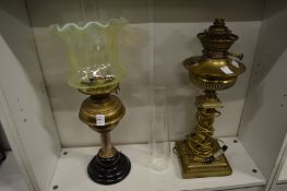 A Victorian oil lamp and another converted to electricity.