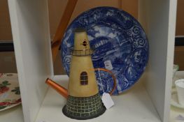 A commemorative plate and a novelty teapot.