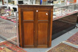 A 19th century mahogany hanging corner cupboard.