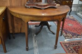 A mahogany demi-lune side table.