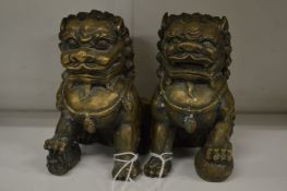 Two cast metal Chinese lions.
