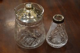 A silver topped glass jar and another item.