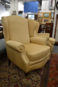 A pair of modern Georgian style upholstered wing armchairs.