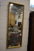 A gilt framed mirror.