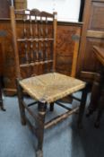 A set of six 19th century fruitwood spindle back and rush seated dining chairs.