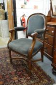 A Victorian carved mahogany framed open armchair or desk chair.