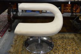 A stylish and unusual revolving chair on chrome support.