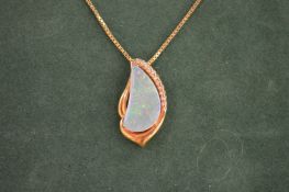 A good gold, diamond and opal pendant on a 15ct gold boxlink chain.