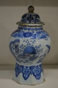 A blue and white jar and cover.
