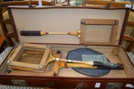A case containing old badminton and tennis racquets.