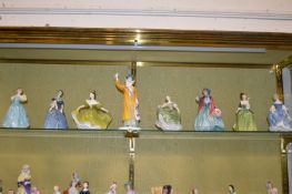 A group of eight Royal Doulton figurines.