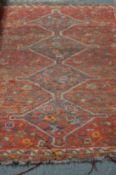 A Persian rug, worn.