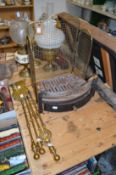 A three-piece brass companion set, a fire grate and a spark guard.