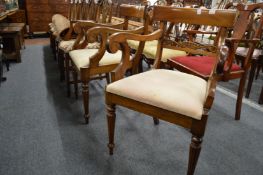 A pair of Regency style mahogany armchairs.