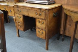 A George III kneehole sideboard or dressing table with brushing slide, one long drawer and four