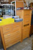 A pair of modern oak two drawer bedside chests with a matching chest of drawers.