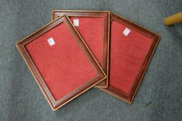 Three Harrods embossed leather photograph frames.
