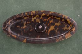 A tortoiseshell dish.