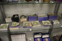 A collection of Wedgwood green Jasper ware trinket boxes, vases and dishes, all boxed.