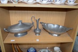 A pewter oval tureen and cover, a similar twin handled basket and a small ewer.