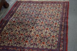 A Persian rug, beige ground with floral decoration.