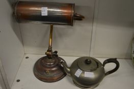 An old desk lamp and a pewter teapot.