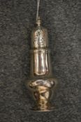 A silver baluster shaped pepperette.