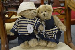 A pair of miniature Teddy bears in Naval style clothing.