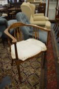 An Edwardian inlaid mahogany occasional armchair.