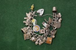 A silver charm bracelet and numerous charms.