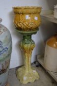 A pottery jardiniere and stand.