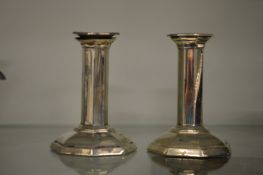 A pair of silver octagonal shaped candlesticks.