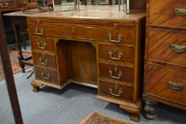 A Georgian style mahogany kneehole pedestal desk.